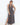 Woman wearing a patterned dress with a white background
