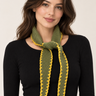 a woman wearing a cashmere dark green knit with yellow-green stitching