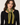 a woman wearing a cashmere dark green knit with yellow-green stitching