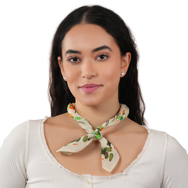 Woman wearing a floral scarf around her neck on a white background