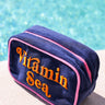 Navy blue pouch with 'Vitamin Sea' text by a pool