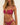 Woman wearing a pink swimsuit set against a white background