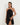 Woman wearing a black halter neck dress on a white background