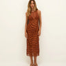 Woman wearing a brown zebra-striped dress against a white background