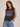 A woman wearing a sleeveless tank with 80s style band logo on front