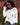A woman wearing sunglasses and a white distressed skull printed knit sweater.