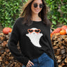 A woman wearing a black knit sweater with a ghost wearing orange heart sunglasses