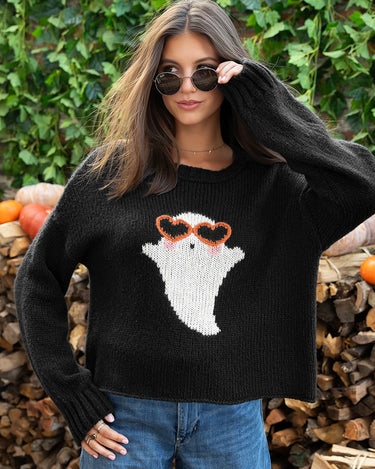 A woman wearing a black knit sweater with a ghost wearing orange heart sunglasses