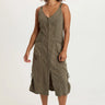 A woman wearing a moss green snap up dress