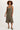 A woman wearing a moss green snap up dress