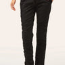 Black drawstring pants with ruched side details and ankle ties, shown on a model wearing black sandals against a light beige studio background.