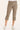 A person wearing taupe-brown cropped cargo pants with side flap pockets and gathered cuffs, paired with white sneakers, shown against a plain light beige studio background.