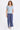 A woman wearing blue twill cargo pants and a light blue short sleeve tee on a white background.