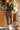  A woman wearing a black track jacket and a  drawstring waist with zippered mini pockets team up with ruched front leg panels, front/back pockets and a cropped silhouette leggings
