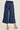 Blue cargo pants worn by a person on a white background