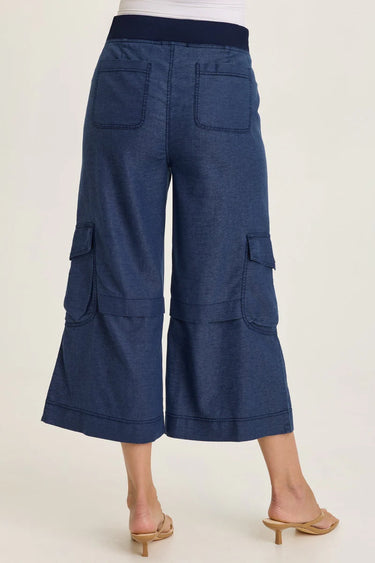 Blue cargo pants worn by a person on a white background