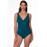 Woman wearing a teal tankini with swimsuit bottoms on a white background