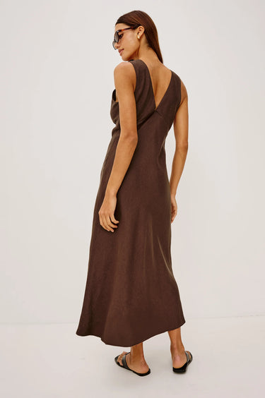 Woman wearing a brown dress on a white background
