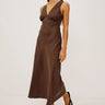 Woman wearing a brown dress on a white background