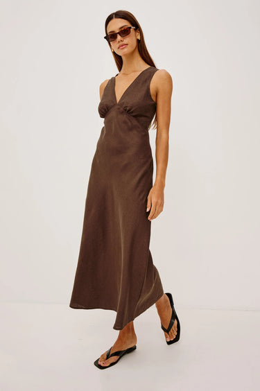 Woman wearing a brown dress on a white background