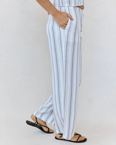 person wearing a striped pair of pants standing sideways
