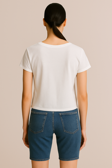 Person wearing a white t-shirt and blue denim shorts on a beige background