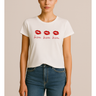 Woman wearing a white t-shirt with red lip prints and text on a beige background