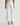 White pants worn by a person on a white background