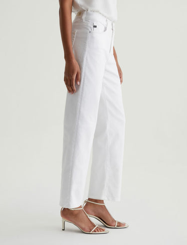 Person wearing white pants on a plain background