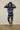 Person wearing a blue and white tie-dye hoodie and pants against a plain background