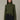 Woman wearing a green turtleneck sweater against a neutral background