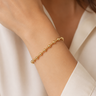 A woman wearing a beaded bracelet 