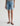 Person wearing light blue denim shorts on a white background