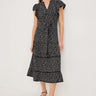 Woman wearing a black and white patterned dress on a white background
