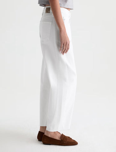 White pants worn by a person on a white background turned sideways
