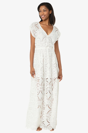 woman wearing a white maxi lace dress with a white backgroun
