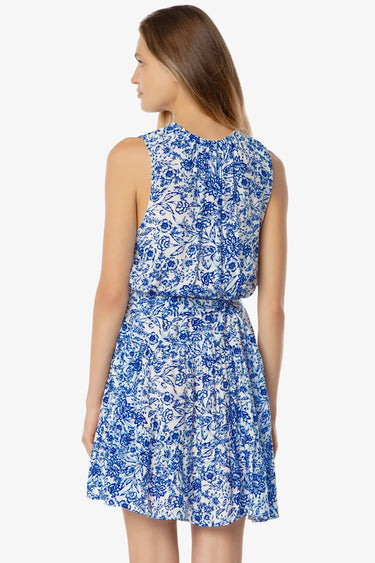 Woman wearing a blue floral dress on a white background
