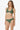 Woman wearing a green bikini on a white background