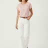 Woman wearing a pink top and white pants on a white background