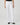 Person wearing white jeans on a plain background