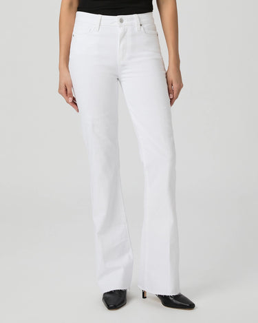Person wearing white jeans on a plain background