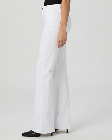 White wide-leg jeans worn by a person on a light gray background