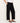 Person wearing black wide-leg pants with a white background
