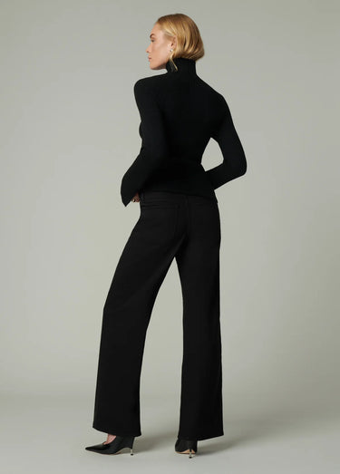 Full back view of Joe’s Jeans Lou Lou Wide Leg Jean in Black styled with a black turtleneck and heels