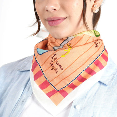 Person wearing a colorful scarf with text and patterns