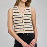 Woman wearing a striped sleeveless cardigan on a gray background