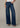 Person wearing blue wide-leg jeans on a neutral background