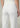White jeans worn by a person on a plain background