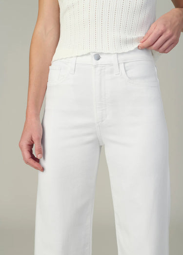 White pants worn by a person on a neutral background