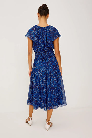 Woman wearing a blue floral dress on a white background